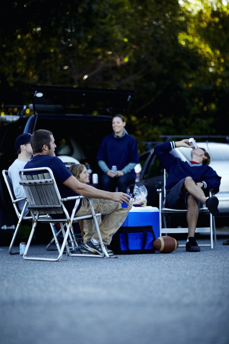 A group of friends at a barbeque or tailgate party at an event.